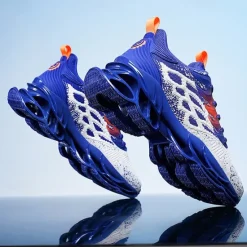 Hot OUKU Men's Blue Athletic Sneakers with Unique Hollow Sole Design, Breathable Knit Upper, and Flame Detail – Lightweight Running Shoes with Orange Accents